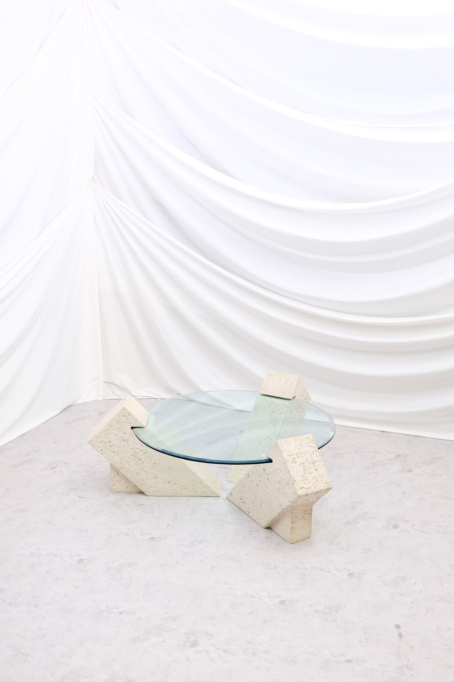 Vintage Brutalist style coffee table with solid stone base and large round glass top. Strong sculptural design. Worldwide shipping available from Helsinki.