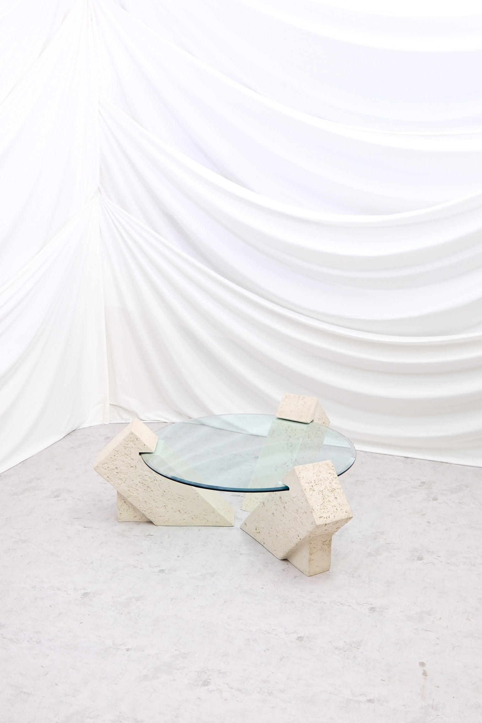Vintage Brutalist style coffee table with solid stone base and large round glass top. Strong sculptural design. Worldwide shipping available from Helsinki.