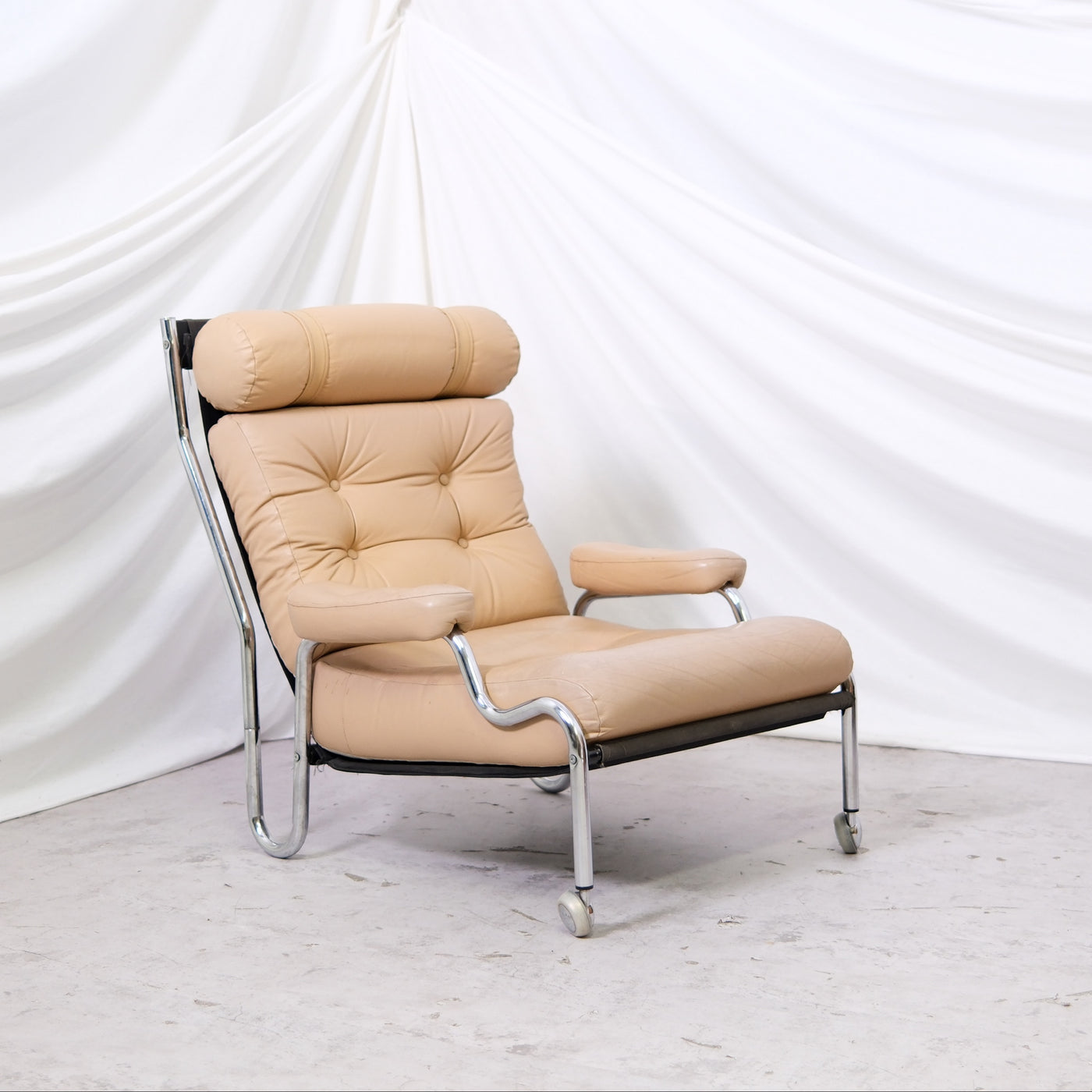 Vintage Danish armchair in beige leather with chrome frame. Light signs of use and great lounge comfort. Helsinki pickup and worldwide shipping available.
