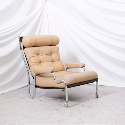 Vintage Danish armchair in beige leather with chrome frame. Light signs of use and great lounge comfort. Helsinki pickup and worldwide shipping available.