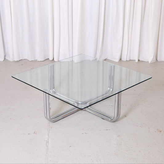 Vintage Italian glass coffee table with square 110 x 110 cm top and chrome tubular steel base. Good vintage condition with minor glass wear.