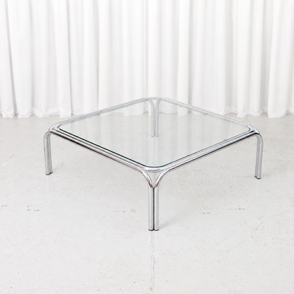 Vintage Italian coffee table with a polished tubular chrome frame and square glass top.