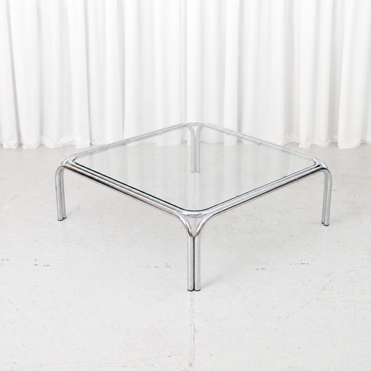 Vintage Italian coffee table with a polished tubular chrome frame and square glass top.