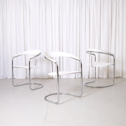 Vintage Italian chrome and white leather dining chairs with curved armrests and open metal frames