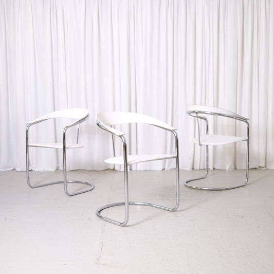 Vintage Italian chrome and white leather dining chairs with curved armrests and open metal frames
