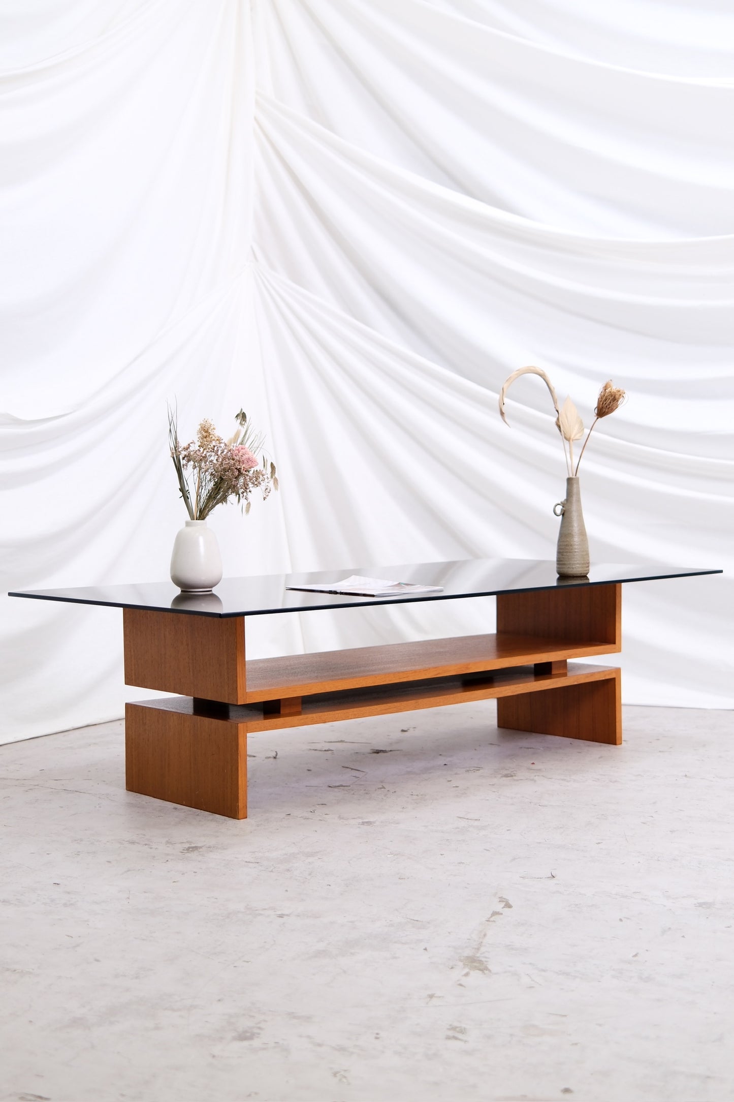 Vintage teak coffee table designed by Jukka Haimi in the 1970s. Smoked glass top, Finnish modern design. Available at Pino Interiors with worldwide shipping.
