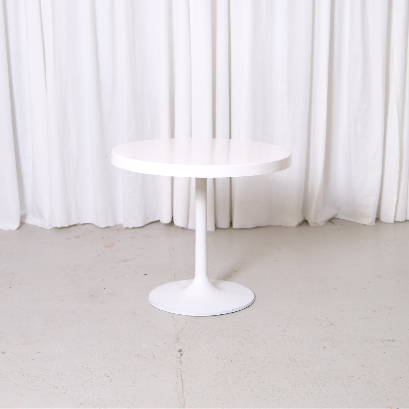 Vintage white Space Age side table with round fiberglass top and metal base