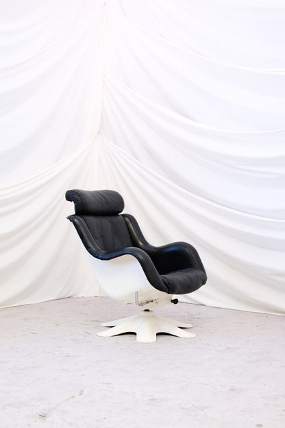 Finnish design classic by Yrjö Kukkapuro for Haimi. Model 418 in black leather with white shell, three recline positions and removable headrest. Worldwide shipping.