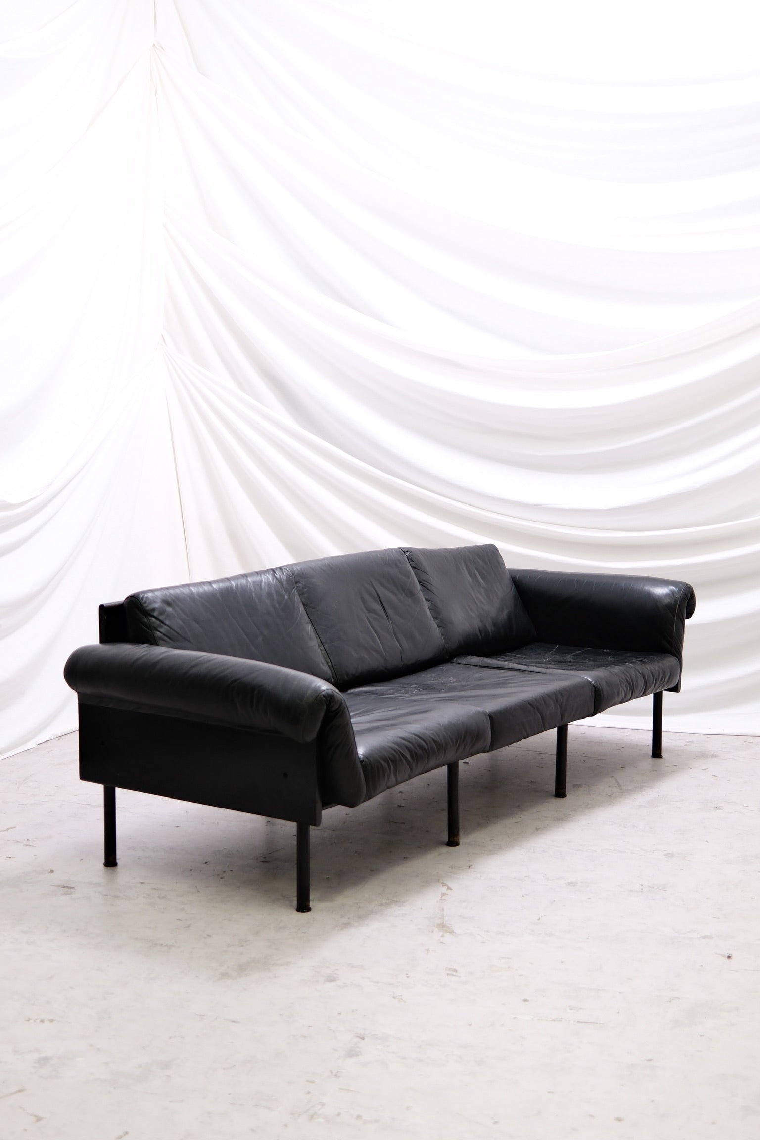 Vintage Yrjö Kukkapuro Ateljee 3-seater sofa by Haimi in black leather with black painted frame. Visible wear and patina. Helsinki pickup and worldwide shipping available.