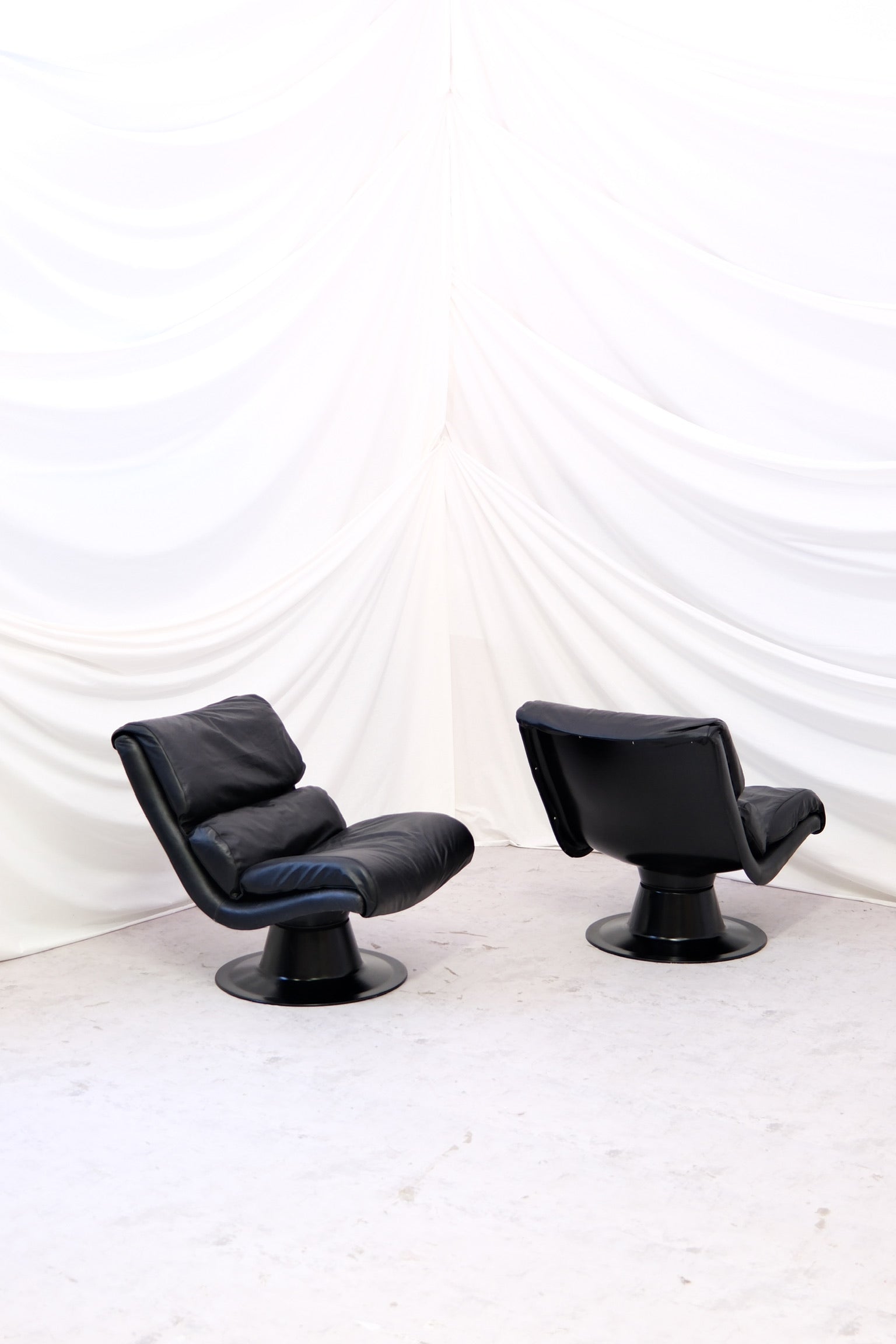 Pair of Yrjö Kukkapuro Saturnus armchairs for Avarte. All black with new leather upholstery, very good condition. Classic Finnish design with worldwide shipping.