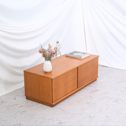 Vintage teak sideboard with sliding doors and warm teak tone. 120 cm wide and ideal as a media console or low storage. Helsinki pickup and worldwide shipping available.
