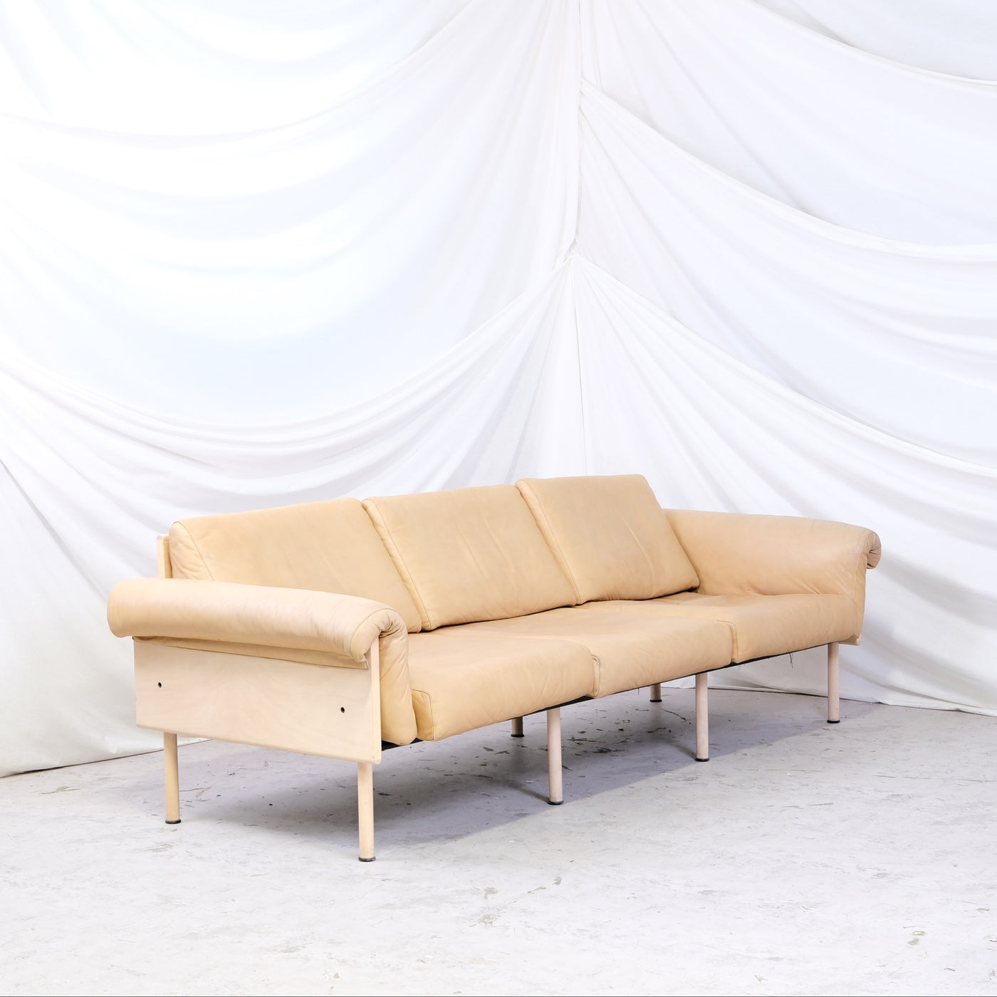 Vintage Yrjö Kukkapuro Ateljee 3-seater sofa with beige leather upholstery and birch frame. Seat straps replaced and in good condition. Worldwide shipping available.