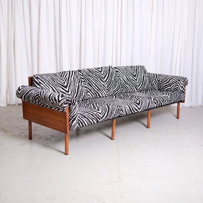 Vintage Yrjö Kukkapuro Ateljee sofa with teak frame, wooden side panels and black and white zebra upholstery.