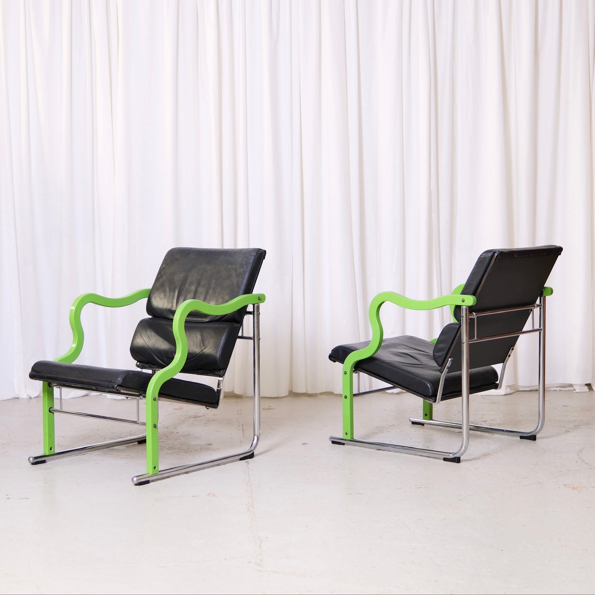 Yrjö Kukkapuro Experiment lounge chair with green lacquered armrests and black leather upholstery
