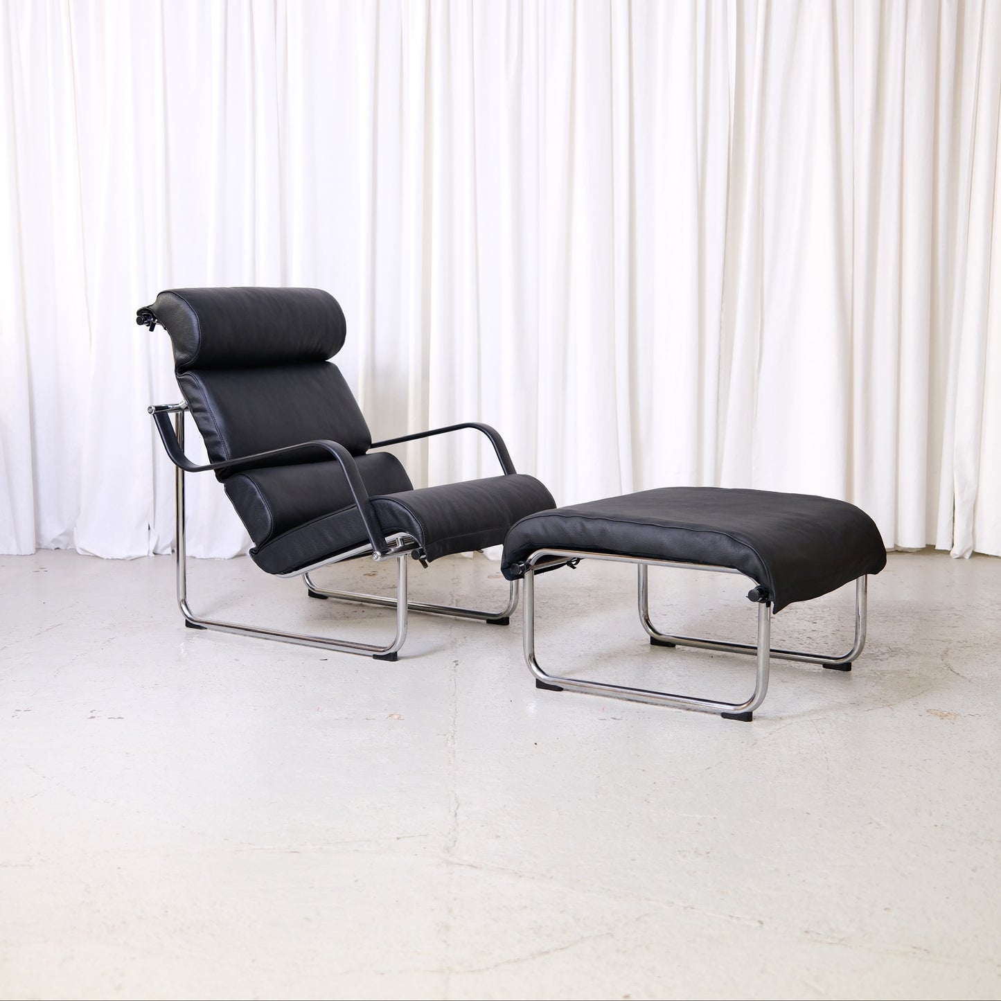 Yrjö Kukkapuro Remmi lounge chair and ottoman in black leather with chrome frame