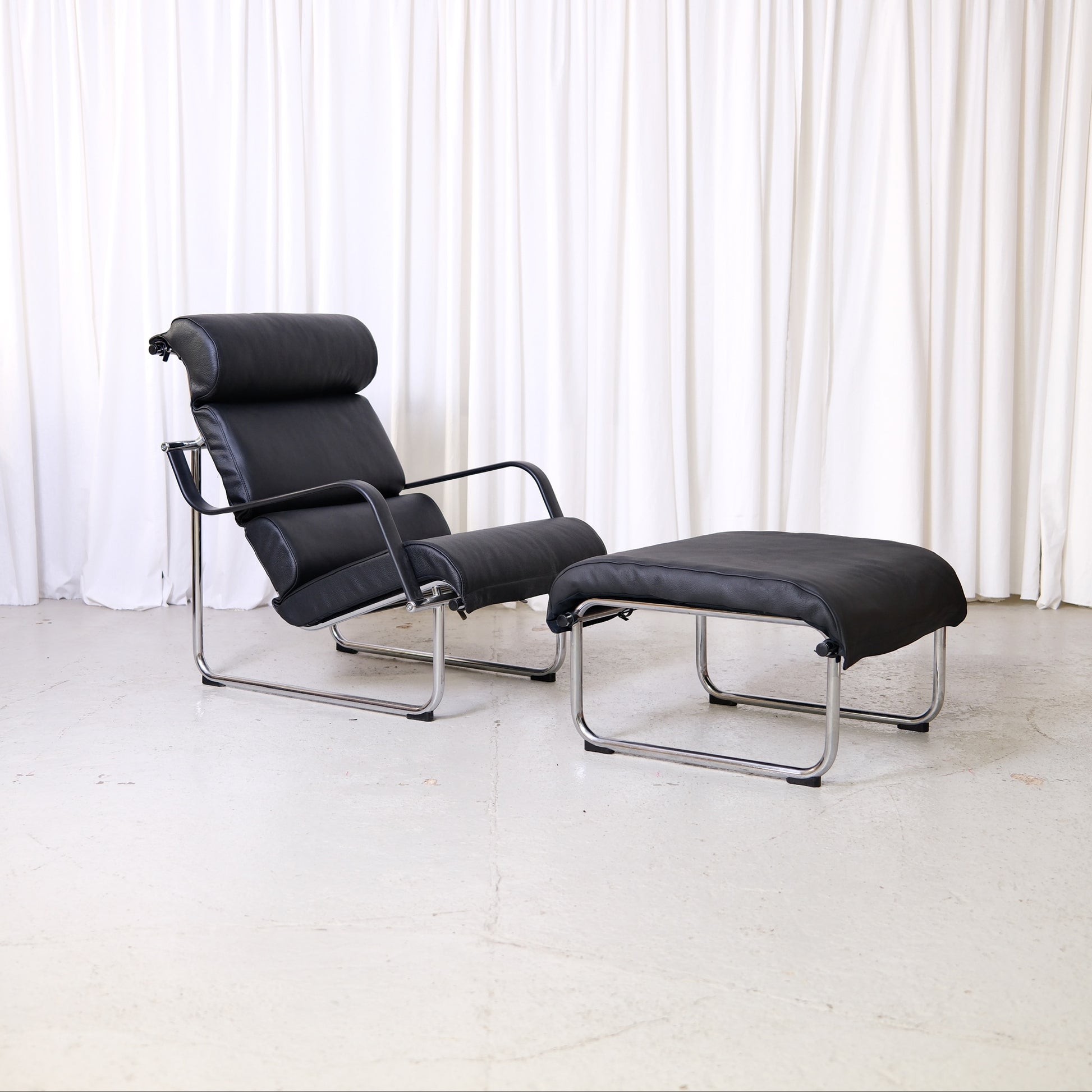 Yrjö Kukkapuro Remmi lounge chair and ottoman in black leather with chrome frame