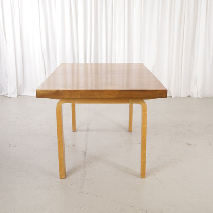Alvar Aalto extendable teak table with figured birch legs — full table view