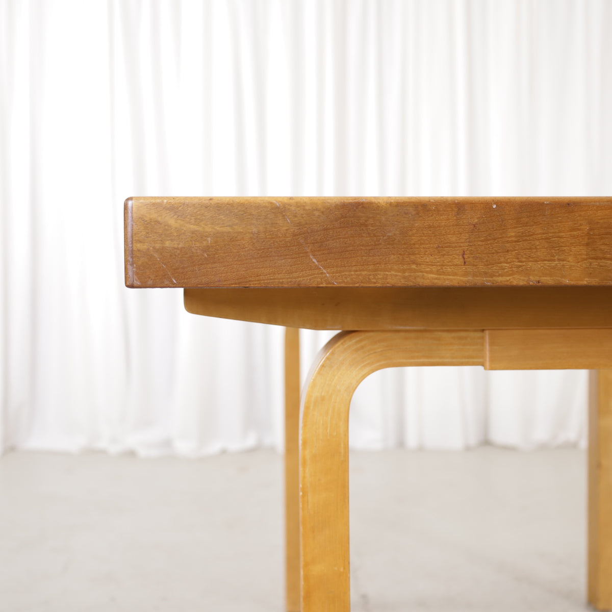 Alvar Aalto extendable teak table with figured birch legs — tabletop, extension leaf or frame detail