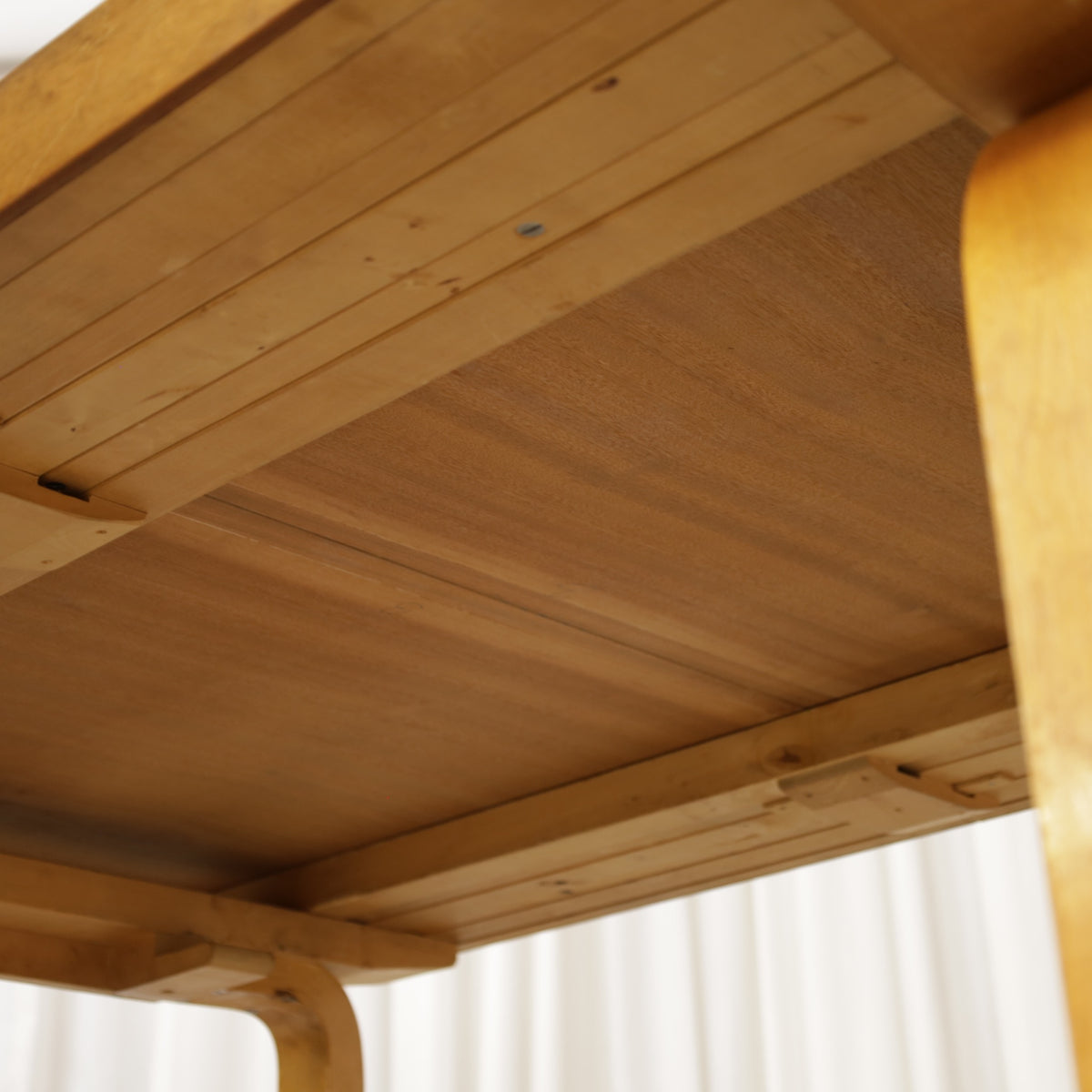 Alvar Aalto extendable teak table with figured birch legs — tabletop, extension leaf or frame detail