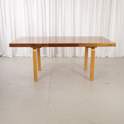 Alvar Aalto extendable teak table with figured birch legs — full table view
