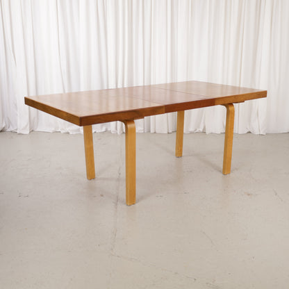 Alvar Aalto extendable teak table with figured birch legs — full table view