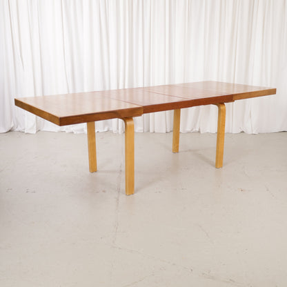 Alvar Aalto extendable teak table with figured birch legs — full table view