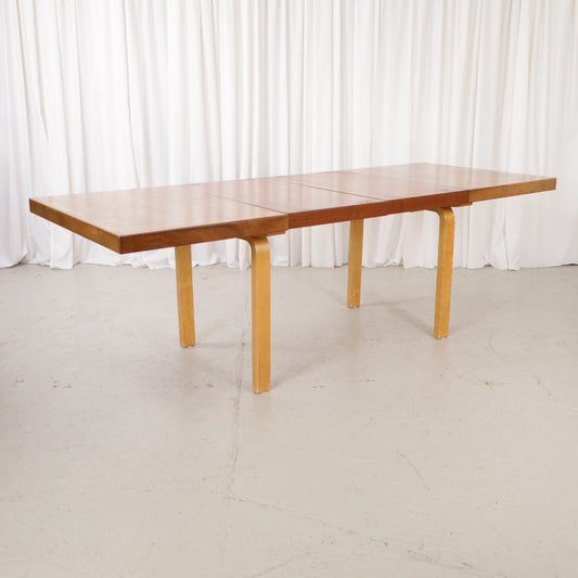 Alvar Aalto extendable teak table with figured birch legs — full table view