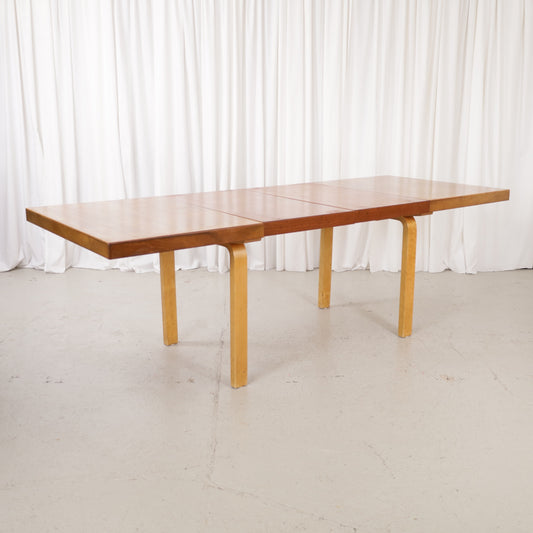 Alvar Aalto extendable teak table with figured birch legs — full table view