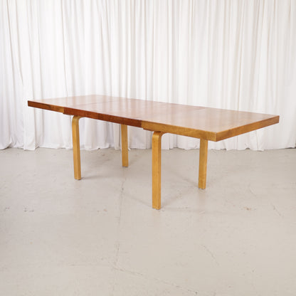 Alvar Aalto extendable teak table with figured birch legs — full table view