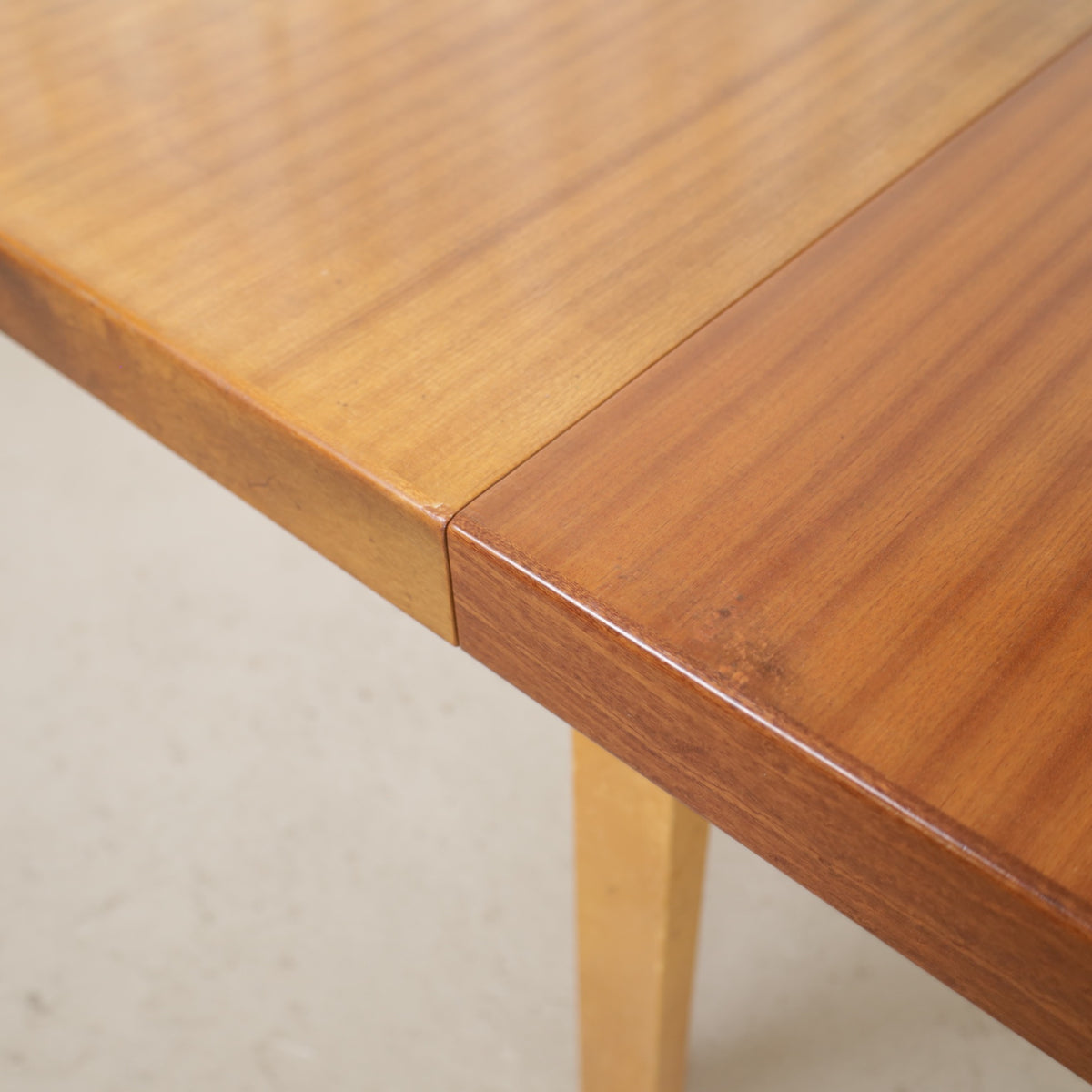 Alvar Aalto extendable teak table with figured birch legs — tabletop, extension leaf or frame detail
