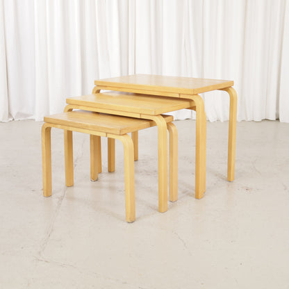 Alvar Aalto nesting tables for Artek, patinated wooden surfaces and bent legs