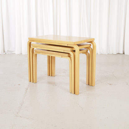 Alvar Aalto nesting tables for Artek, patinated wooden surfaces and bent legs