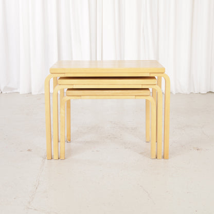 Alvar Aalto nesting tables for Artek, patinated wooden surfaces and bent legs