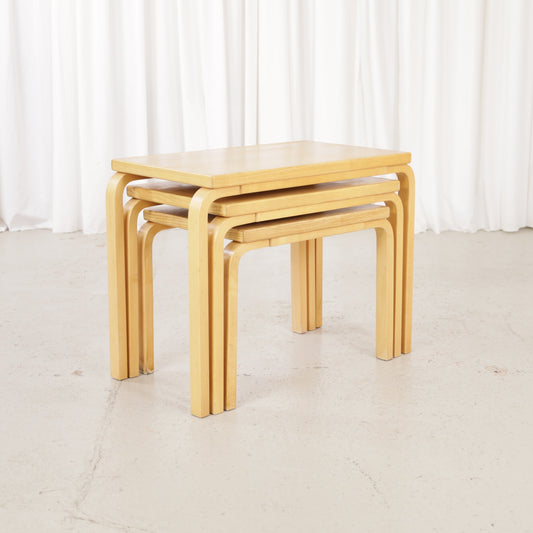 Alvar Aalto nesting tables for Artek, patinated wooden surfaces and bent legs