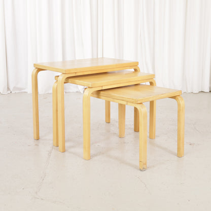 Alvar Aalto nesting tables for Artek, patinated wooden surfaces and bent legs