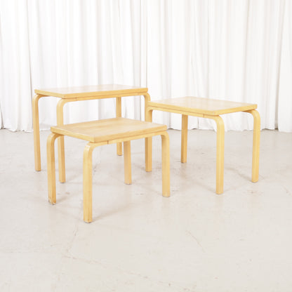 Alvar Aalto nesting tables for Artek, patinated wooden surfaces and bent legs