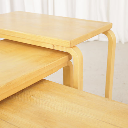 Alvar Aalto nesting tables for Artek, patinated wooden surfaces and bent legs