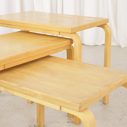 Alvar Aalto nesting tables for Artek, patinated wooden surfaces and bent legs