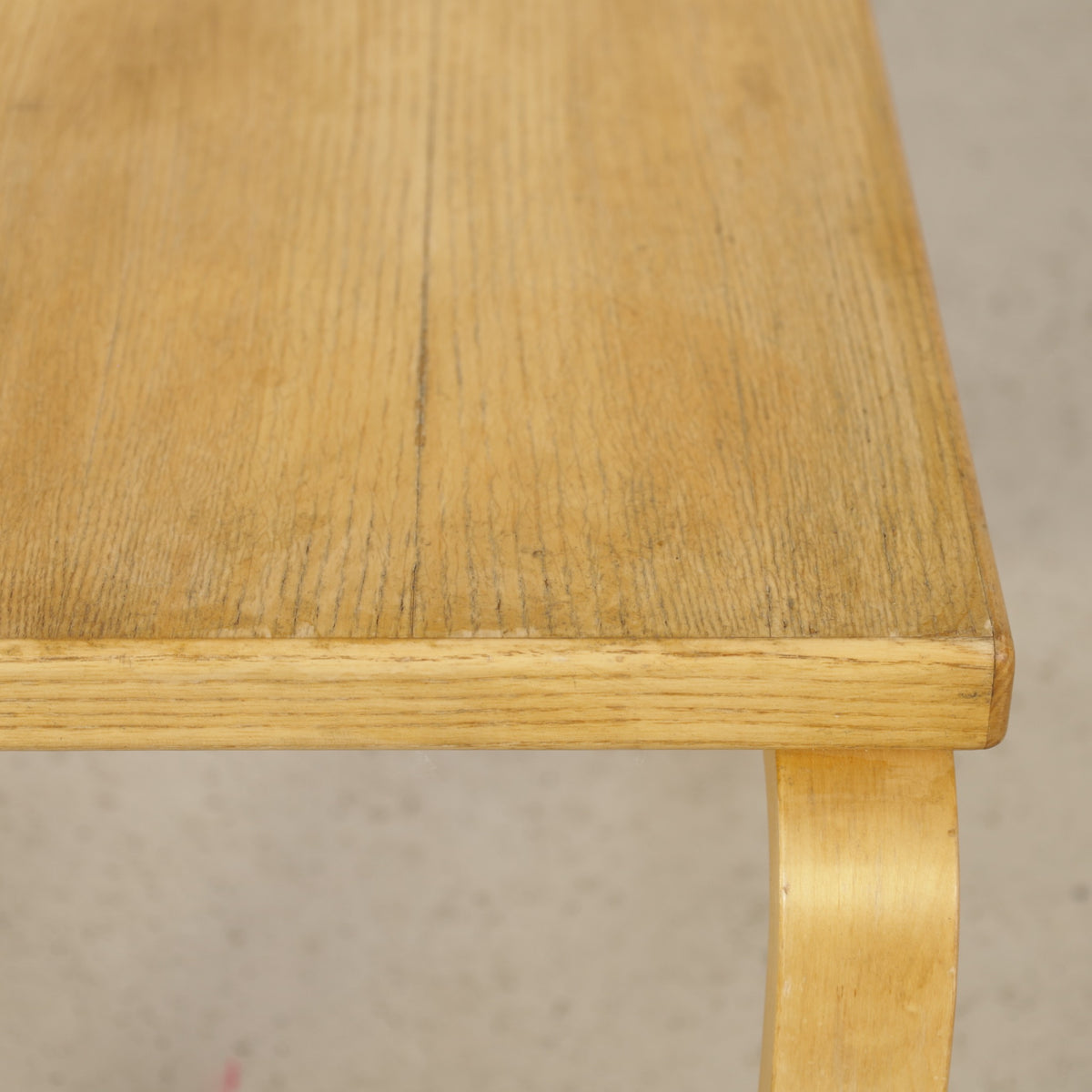 Alvar Aalto nesting tables for Artek, patinated wooden surfaces and bent legs — surface and edge wear detail