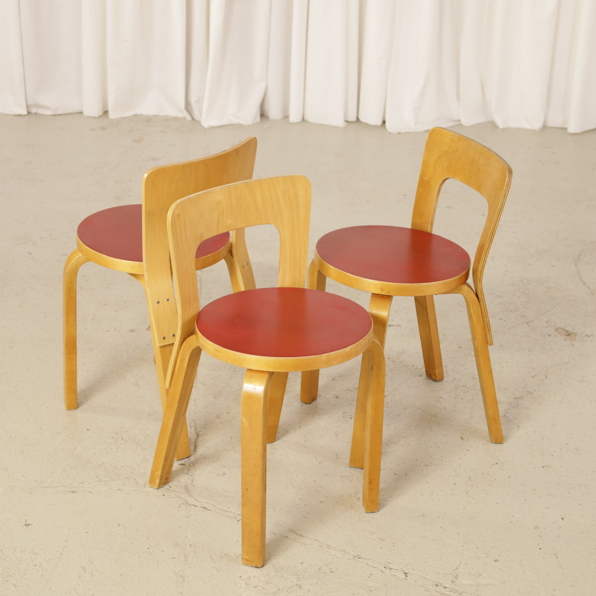 Alvar Aalto Chair 65 in Birch and Red Linoleum for Artek, group of three Alvar Aalto Chair 65 chairs in birch with red linoleum seats
