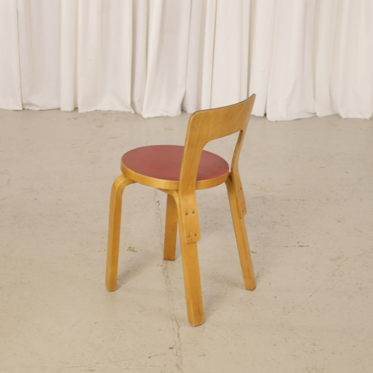 Alvar Aalto Chair 65 in Birch and Red Linoleum for Artek, rear three-quarter view of Alvar Aalto Chair 65 in birch