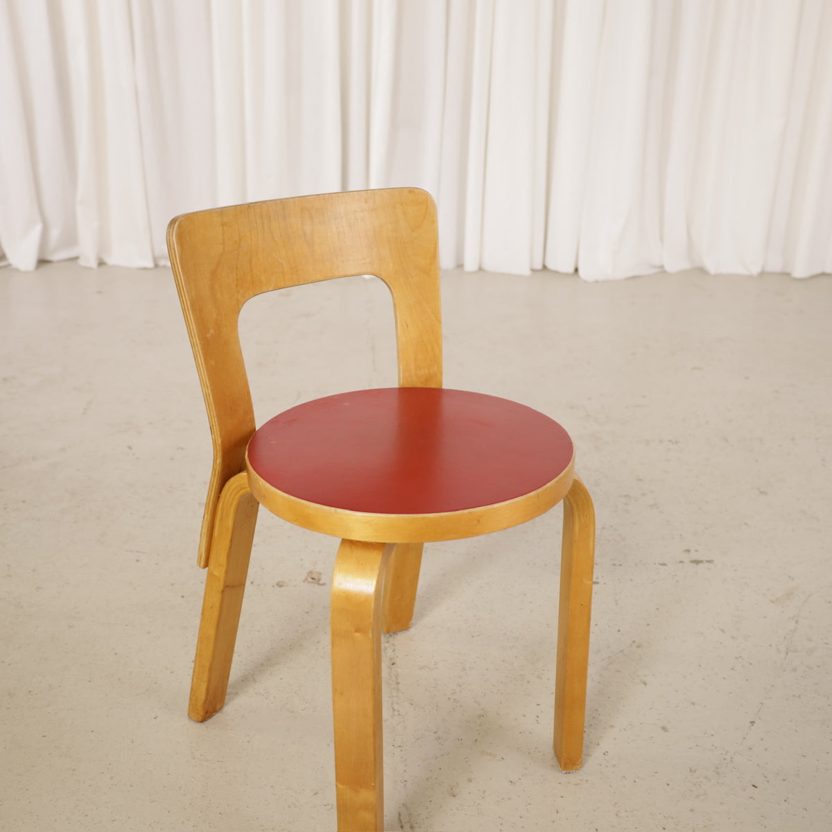Alvar Aalto Chair 65 in Birch and Red Linoleum for Artek, front three-quarter detail of Chair 65 with red linoleum