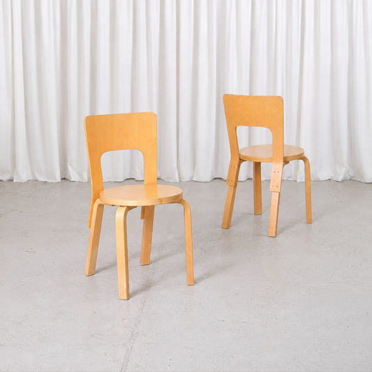 Pair of vintage Artek Chair 66 chairs by Alvar Aalto in natural birch, angled view