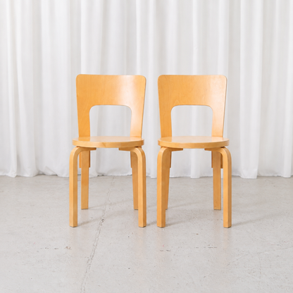 Pair of vintage Artek Chair 66 chairs by Alvar Aalto in natural birch, front view