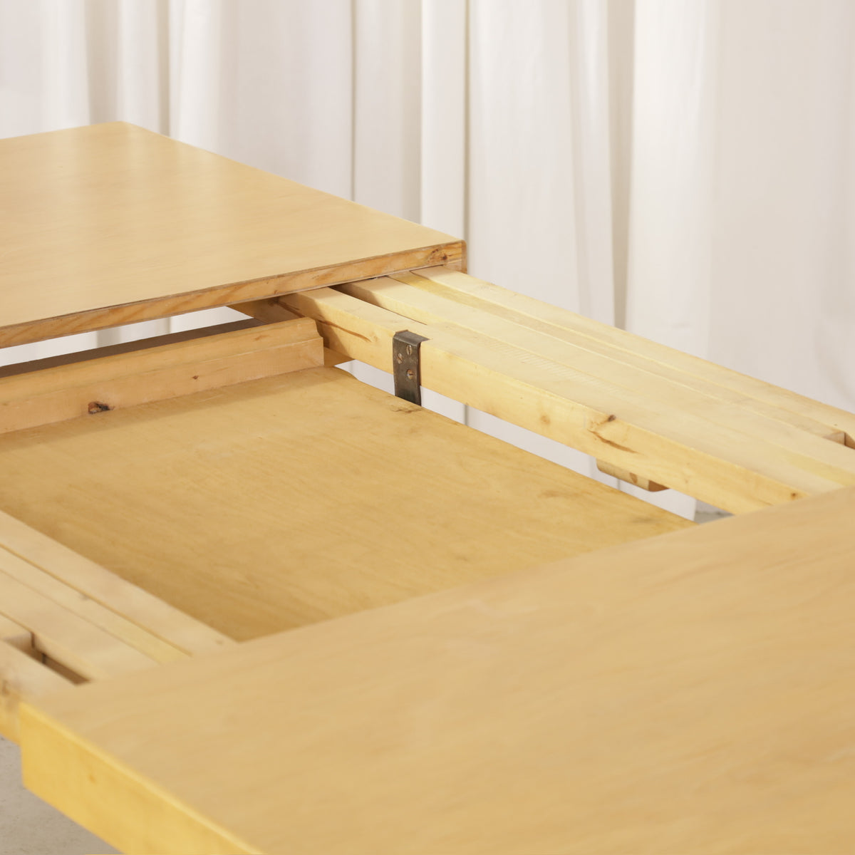 Alvar Aalto Model 92 Extendable Dining Table by Artek, detail of the extension mechanism on Alvar Aalto Model 92 table by Artek