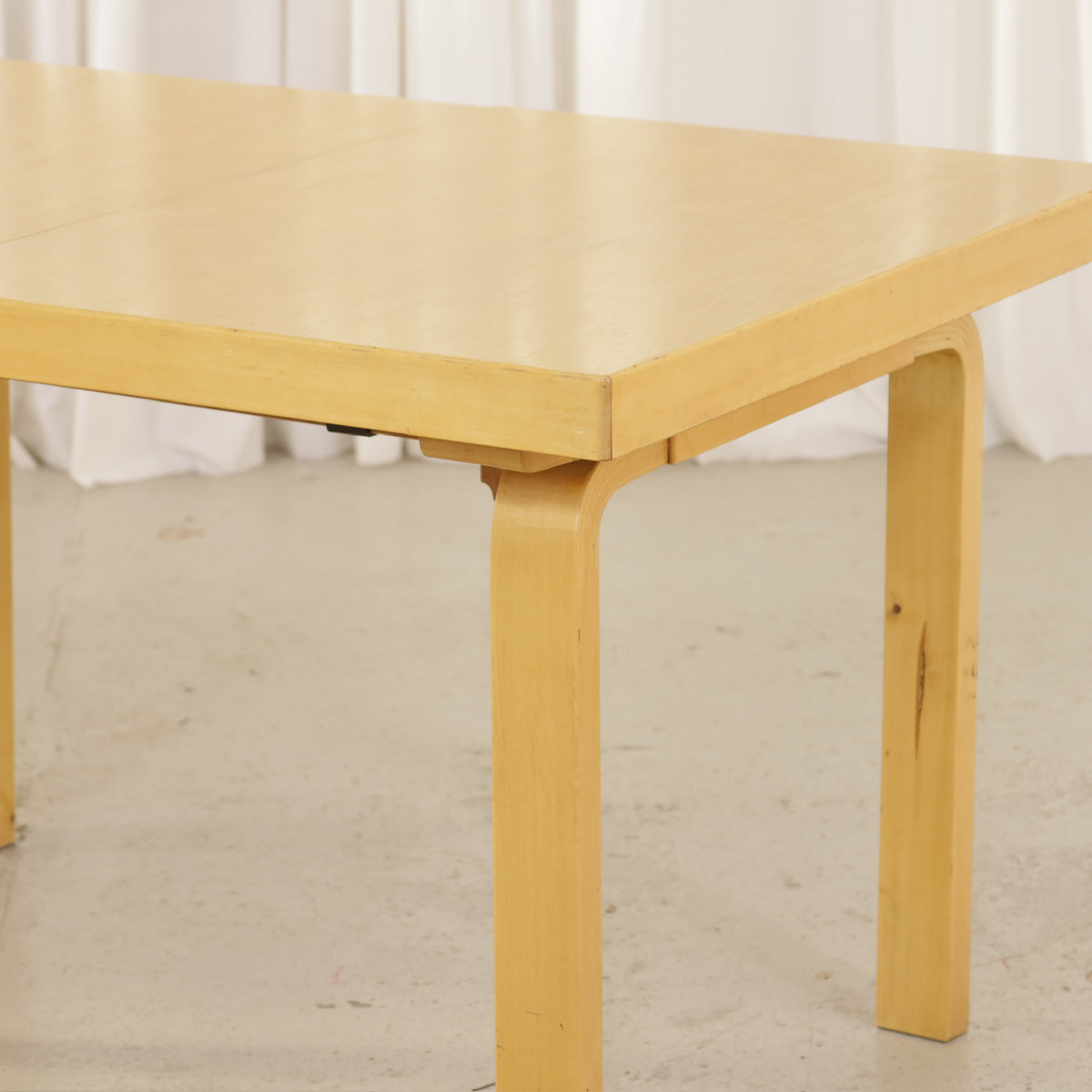 Alvar Aalto Model 92 Extendable Dining Table by Artek, tabletop and bent birch leg detail on Alvar Aalto Model 92 table by Artek