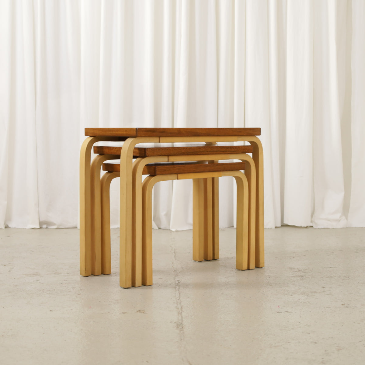 Alvar Aalto Nesting Table Set in Mahogany and Birch, 1950s, three wooden tables nested together, front view