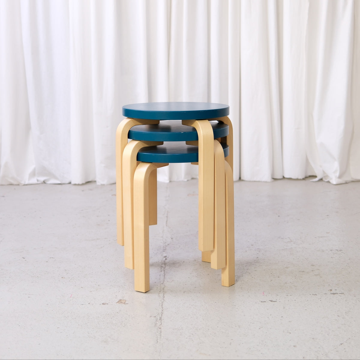 Alvar Aalto Stool E60 with Blue-Green Seat for Artek, three Alvar Aalto Stool E60 stools with blue-green seats and birch legs for Artek, stacked