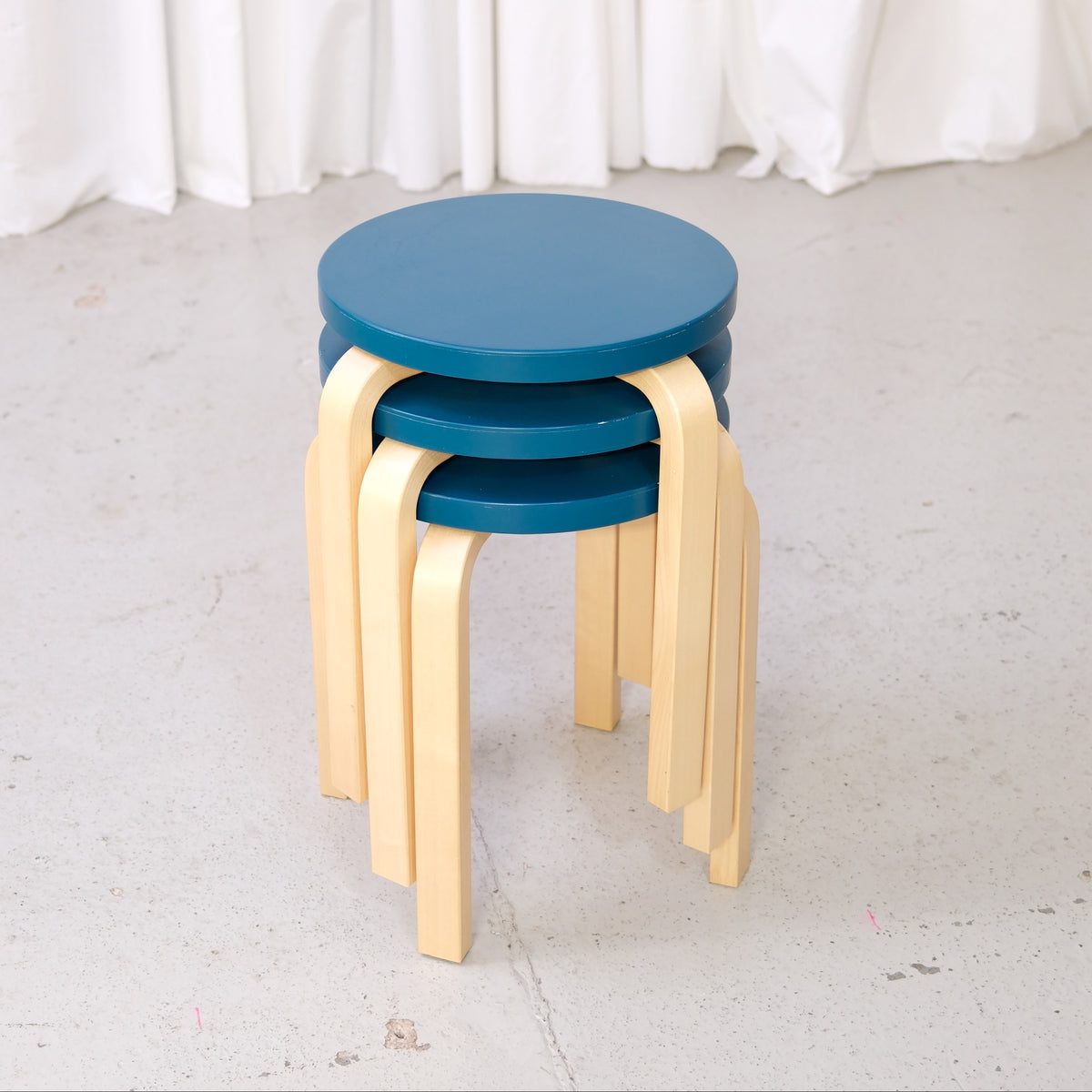 Alvar Aalto Stool E60 with Blue-Green Seat for Artek, three Alvar Aalto E60 stools in blue-green painted birch, stacked view