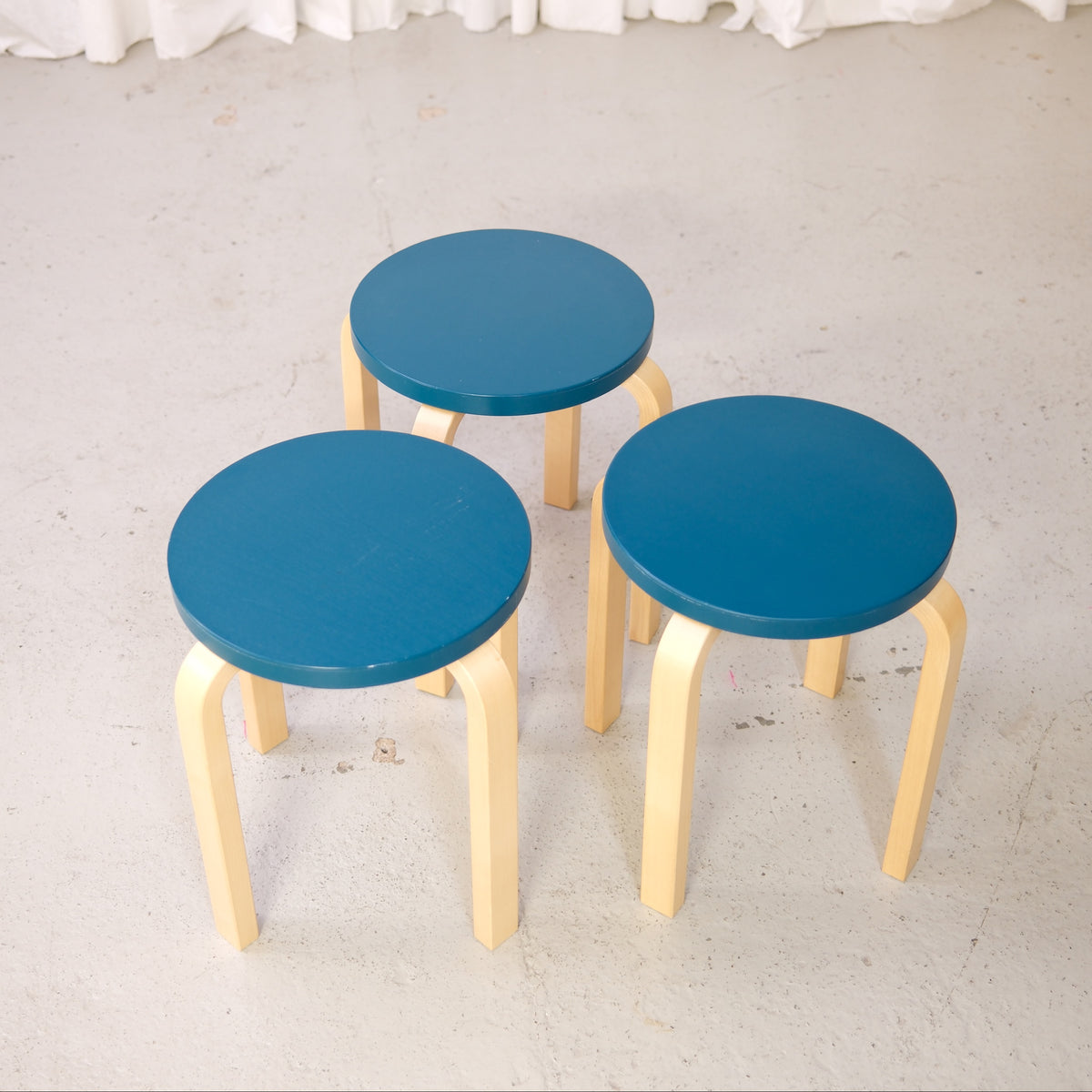 Alvar Aalto Stool E60 with Blue-Green Seat for Artek, set of three Artek E60 stools with blue-green seats and natural birch legs